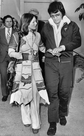 Elvis and Priscilla Presley walking out of court after their divorce, 1973